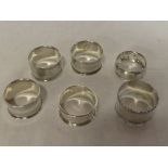 Six various silver circular napkin rings with engraved decoration