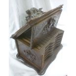 A 19th Century Black Forest carved wood cigar cabinet with six internal sliding trays enclosed by a