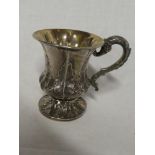A George IV silver pedestal christening tankard with raised leaf decoration and scroll handle,