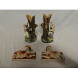 A pair of Continental pottery spill vases in the form of tree trunks with male & female decoration,