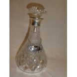 A good quality cut glass tapered decanter and stopper with silver mounted neck supporting a silver