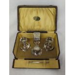 A George V silver five-piece desk set comprising a pair of squat-shaped candlesticks,