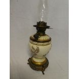 A Victorian brass mounted pottery oil lamp with detachable glass font and floral decoration on