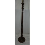 A good quality carved mahogany standard lamp with fluted stem and circular base