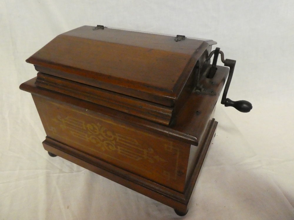 A Royal Orguinette hand cranked music player in walnut rectangular case No.