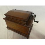 A Royal Orguinette hand cranked music player in walnut rectangular case No.