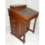 A Victorian walnut Davenport desk with fitted stationary compartment and interior enclosed by