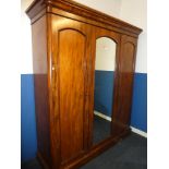 A Victorian figured mahogany triple wardrobe with internal drawers,