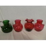 A pair of Cranberry tinted glass tapered jugs with loop handles,