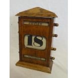 An Edwardian oak cased perpetual desk calendar with glazed front,