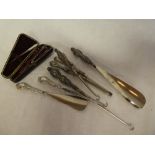 A selection of silver handled button hooks, shoe horns, glove stretcher,