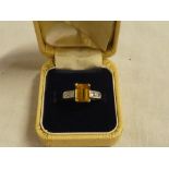 An 18ct gold dress ring set rectangular yellow sapphire flanked by four small diamonds