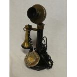 A brass mounted and painted metal candlestick-style telephone