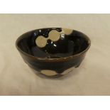 A Japanese 19th Century Kioto pottery circular tea bowl with brown glazed decoration, signed,