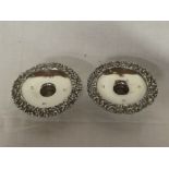 A pair of good quality modern silver circular candle holders with decorated borders,