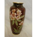 A Crown Devon Fieldings china tapered vase with floral decoration on red ground,