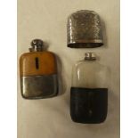 A silver plated and leather covered glass hip flask with engraved decoration and one other similar