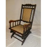 A 19th Century walnut American style rocking chair with upholstered seat and back pad on standard