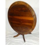 A Regency brass inlaid rosewood circular tilt-top breakfast table on rectangular column with