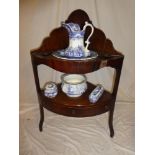 A 19th Century mahogany two-tier corner wash stand with a single drawer in the frieze on square