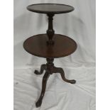 A 19th Century mahogany circular two-tier dumb waiter with turned colomn and tripod base