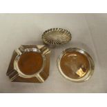 A small silver circular pin dish by Garrard & Co; silver square ashtay,