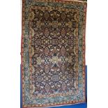 A good quality Eastern hand-knotted wool rug with floral decoration on blue ground,