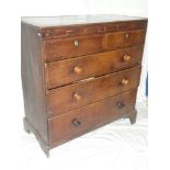 A George III oak and mahogany cross banded chest of two short and three long drawers with turned
