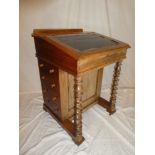 A Victorian walnut Davenport desk with maple lined interior with fitted drawers enclosed by a