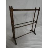 A Victorian walnut towel rail with turned supports