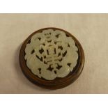 A Chinese carved jade circular panel with pierced decoration,