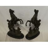 A pair of spelter figures of classical males with rearing horses,
