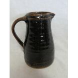 A St Ives Studio Pottery tapered jug with brown/black glazed decoration,