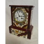 A Victorian mantel clock with enamelled circular dial in floral decorated ceramic rectangular case