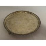 A George V silver circular salver with decorated edge, Birmingham marks 1934,