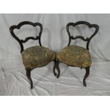 Three Victorian rosewood occasional chairs with arched rail backs and floral upholstered seats on