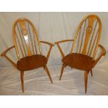 A set of six 1960's/70's Ercol light elm dining chairs comprising four single and two carver chairs,