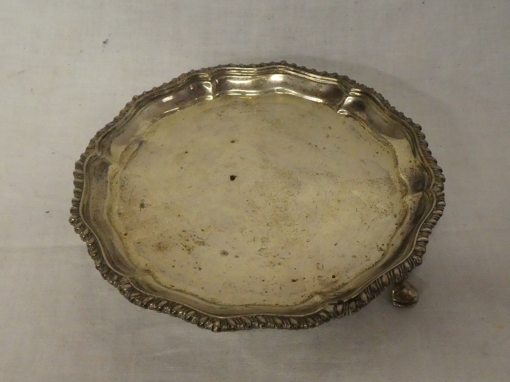 A late Victorian silver circular waiter tray with decorated edge, 6" diameter,