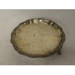 A late Victorian silver circular waiter tray with decorated edge, 6" diameter,