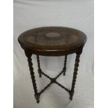 A good quality 1930's oak circular occasional table with cane work bergere-style top on barley