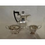 A good quality silver plated three-piece coffee set comprising tapered coffee pot with ebonised