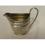 A George III silver oval cream jug with engraved decoration and loop handle, London marks 1799,