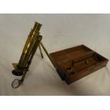 An unusual brass monocular microscope by Baker of London with twin folding legs in fitted mahogany