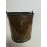 A 19th Century copper cylindrical bucket with iron swing handle,