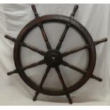 A large old mahogany ship's wheel,