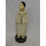 An Art Deco alabaster & ivory figure of a standing clown on black marble base,