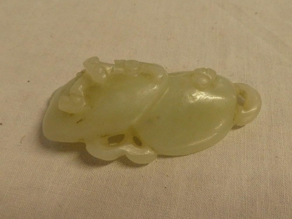 A Chinese carved jade figure of two mushrooms with raised decoration,