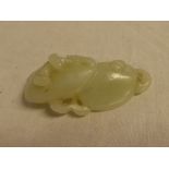 A Chinese carved jade figure of two mushrooms with raised decoration,