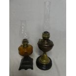 A 19th Century copper and brass oil lamp with fluted base and one other oil lamp with tinted glass