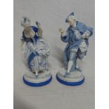 A pair of Continental china figures of a classical male and female on circular bases,